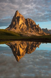 Gusela mountain at sunrise reflected in small lake