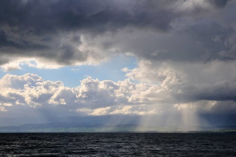 Storm clouds and sunbeams above Lake Geneva