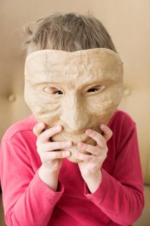 Girl hiding face behind mask