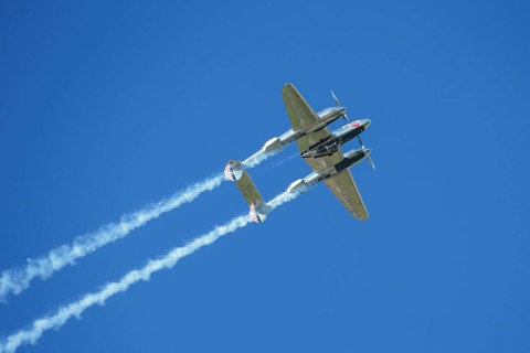 A Lockheed P-38 Lightning flying in a flight display during the Red Bull Air Race