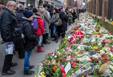 Flowers and flags to commemorate the victim of the terrorist attack that killed a man at Copenhagen's main synagogue on 15 February 2015