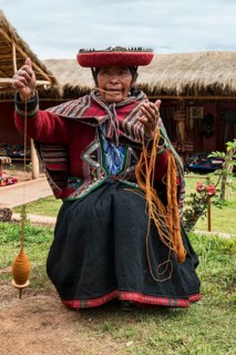 Indigenous woman spinning wool