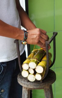 Men's hands tying cane rods for sale