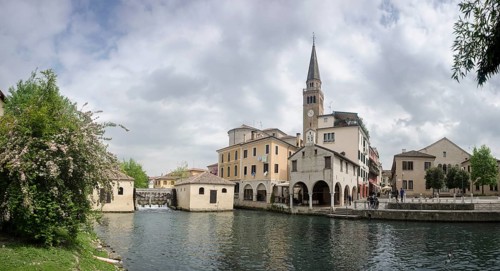 The leaning tower of the cathedral and the old mill