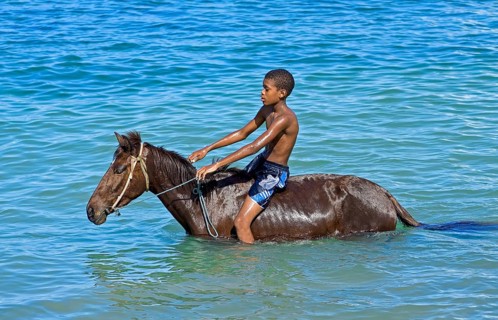Boy on horseback in the sea