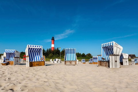 Beach chairs on the beach in front of the lighthouse