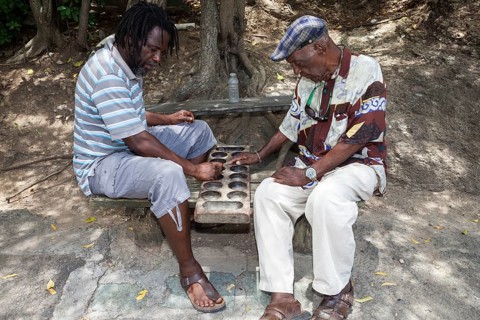 Two local men playing a board game called Warri