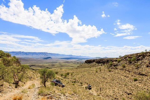 SUV driving through arid landscape