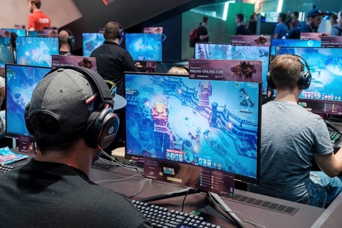 Visitors play video games at Gamescom