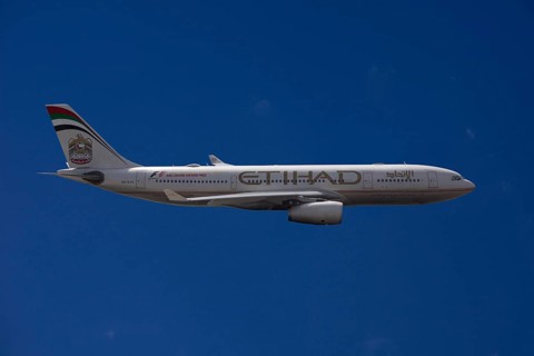 A6-EYK Etihad Airways Airbus A330-243 in flight against a blue sky
