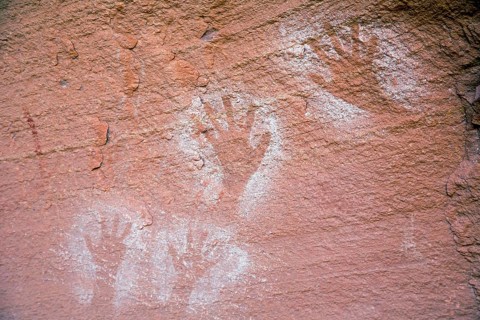 Ancient Anasazi hand pictographs on a cliff high above the Colorado River