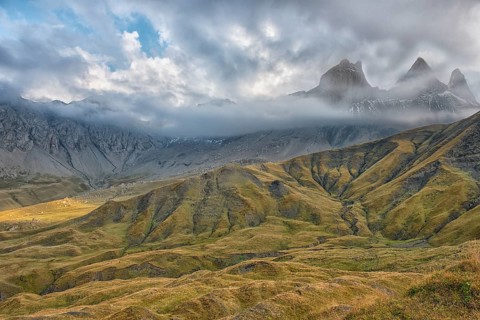 Pelvoux landscape with the Les Aiguilles d'Arves mountain between fog and clouds
