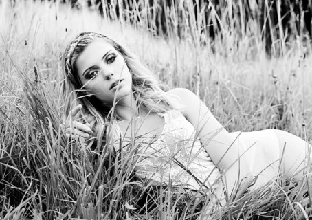 Young woman in lingerie posing outdoors