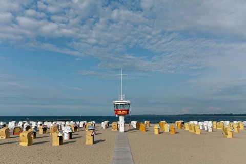 Empty sandy beach with beach chairs and DLRG-lifeguard tower