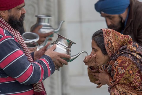 Pilgrims drinking holy water