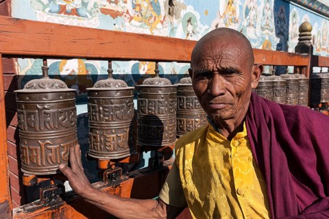 Monk turning prayer wheels