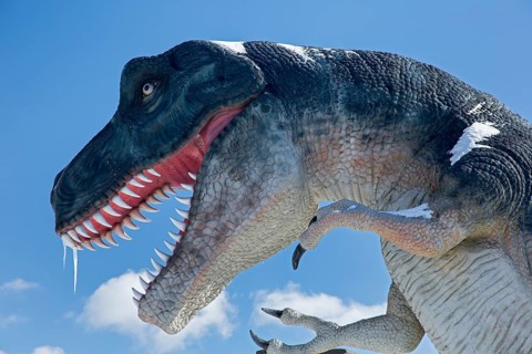 A dinosaur sculpture in a dinosaur park