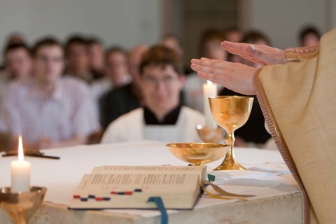 Priest blessing the holy sacrament
