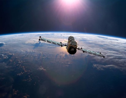 Geostationary orbit military satellite above the Earth pointed toward the rising sun
