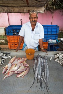Fish monger at his market stall
