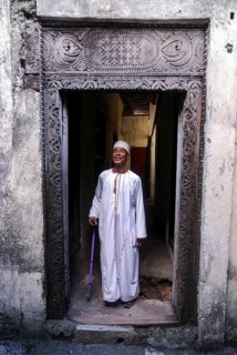 Proud Comorian man standing in doorway
