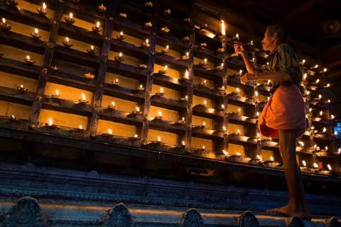Man lighting an oil lamp