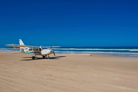Small plane landing on the 75 Mile Beach