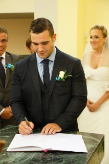 Groom signing the church register after the ceremony