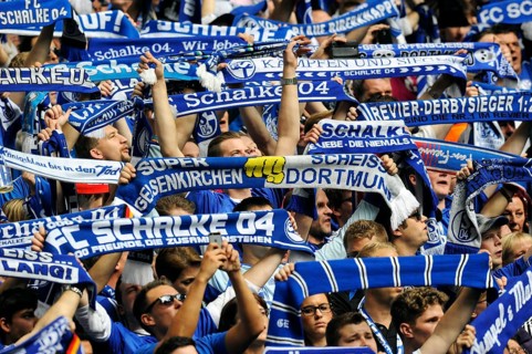 Schalke fans on the north stand holding up scarves
