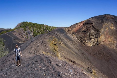 Hikers on a trail at the crater of the Duraznero volcano