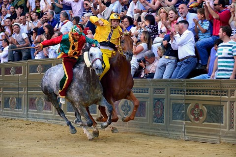 Overtaking manoeuvre of the winner at the historic horse race Palio di Siena