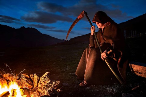 Person with scythe as personified death