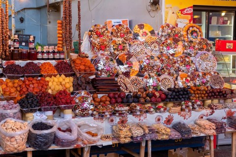 Stall in market hall with candied fruits