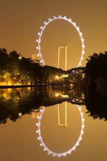 Singapore Flyer reflecting in the water at night