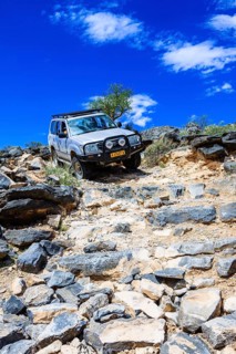 SUV driving down rock steps