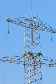 Overhead linemen working on a pylon