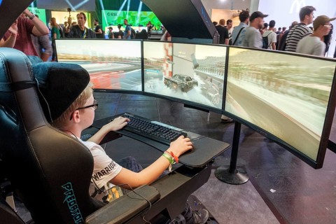 Junge plays simulation of a car race at Gamescom