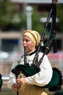 Musician in traditional costume playing the bagpipes