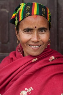 Nepalese woman with colourful headscarf and red cape