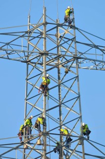 Overhead linemen working on a pylon