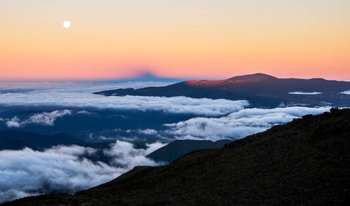 Moonrise and sunset over the Piton de la Fournaise volcano