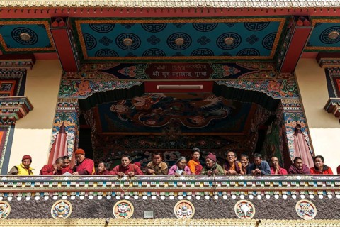 Native people on the balcony of the Cinya Llama Gompa