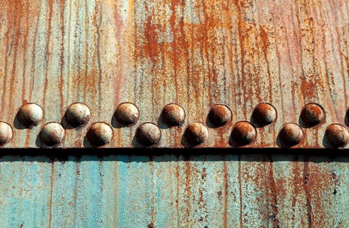 Rusted metal construction with rivets