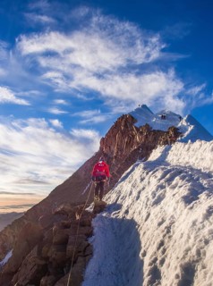 Roped alpinist on the mountain ridge