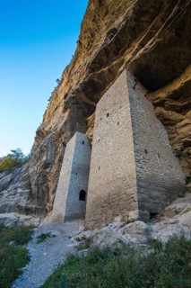 Chechen watchtowers under overhanging cliff on the Argun river
