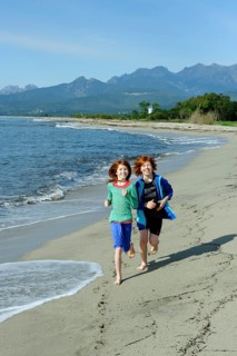 Children running on the beach on the east coast