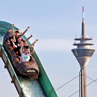 Four young men on the log flume in front of the Rhine Tower