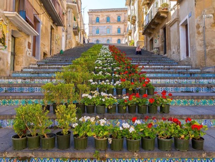 The Santa Maria del Monte staircase with ceramic tiles and potted plants