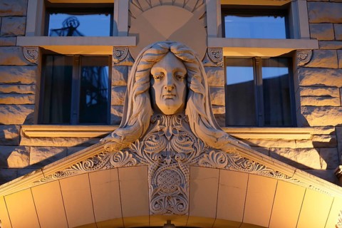Sculpture of a woman's head over the Art Nouveau entrance of the Neiburgs Hotel