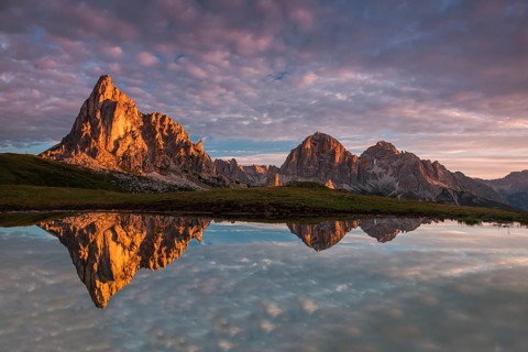 Gusela mountain at sunrise reflected in small lake